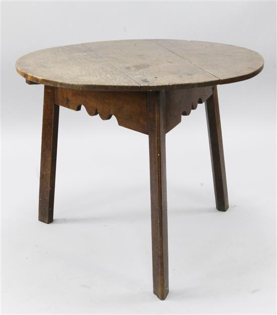 An early 19th century oak circular topped cricket table, diameter 2ft 9in.
